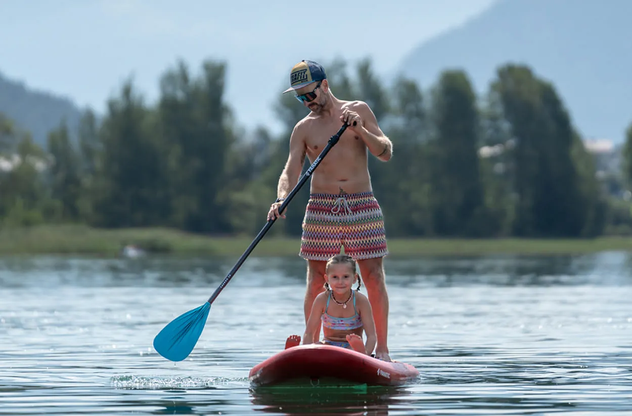 Mann mit Kind am SUP